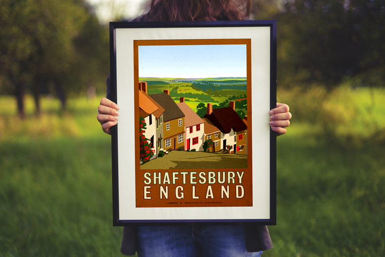 A woman holding the framed Travel poster